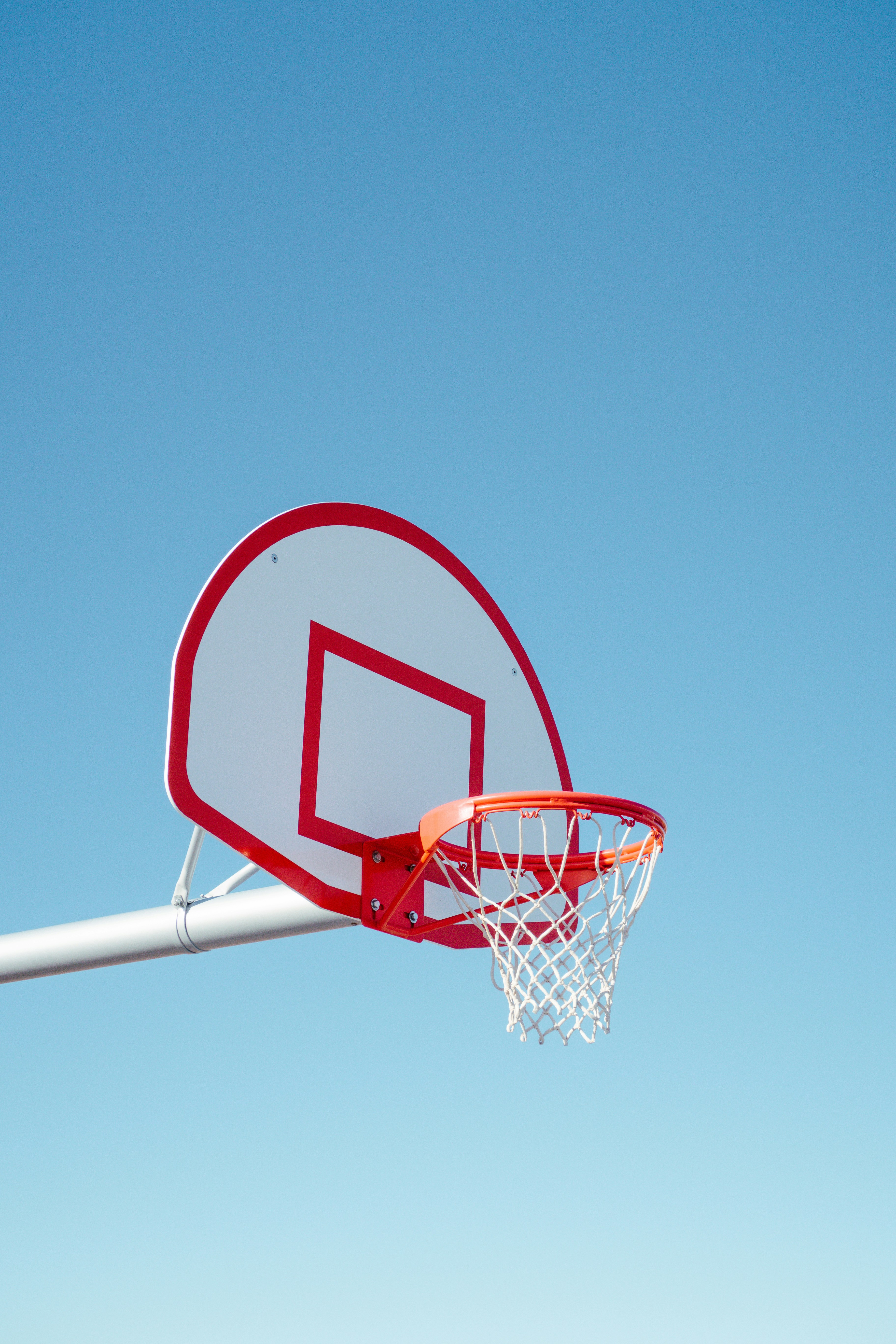 Basketball hoop against blue sky